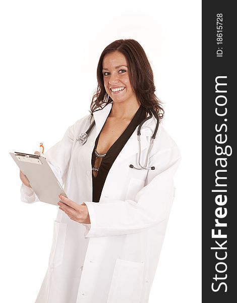 A woman doctor is standing with a clipboard and a smile. A woman doctor is standing with a clipboard and a smile.