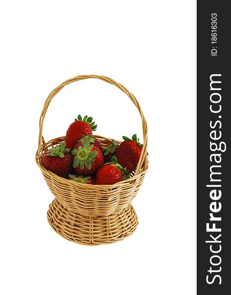Fresh strawberries in small interwoven straw basket isolated on white background. Fresh strawberries in small interwoven straw basket isolated on white background