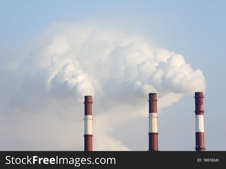 Three smoking chimneys other blue sky