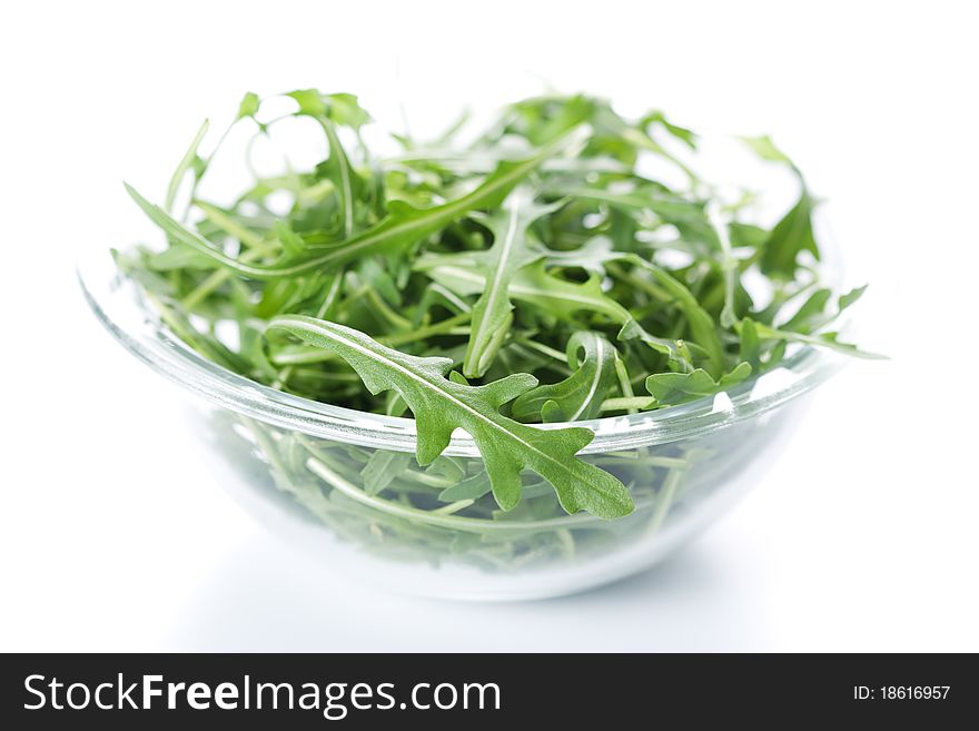 Green rucola fresh salad in glass bowl
