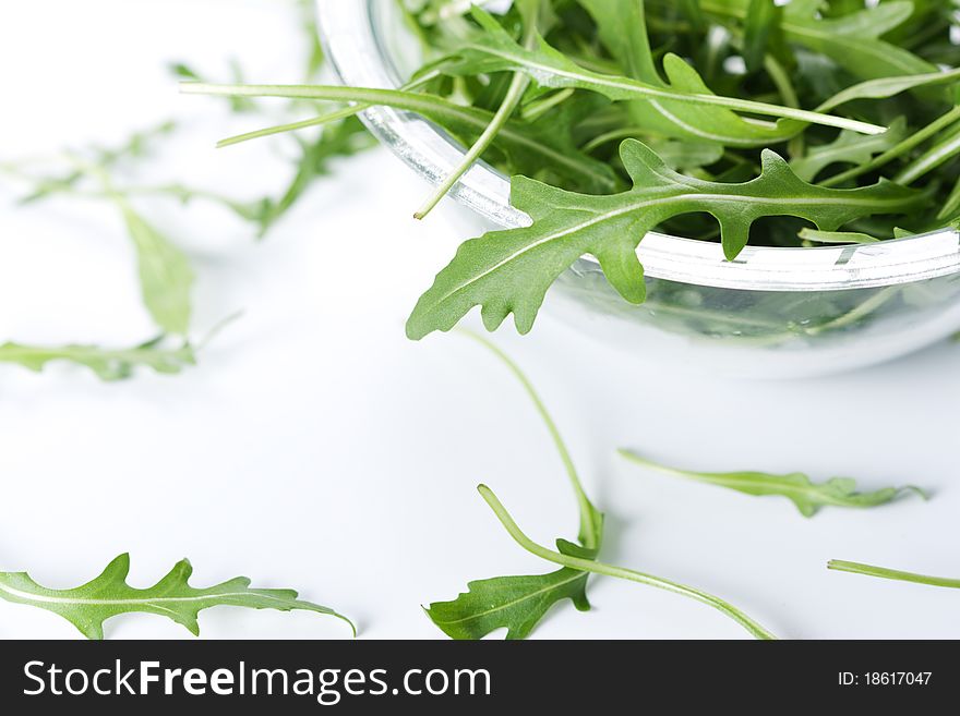 Green rucola fresh salad in glass bowl