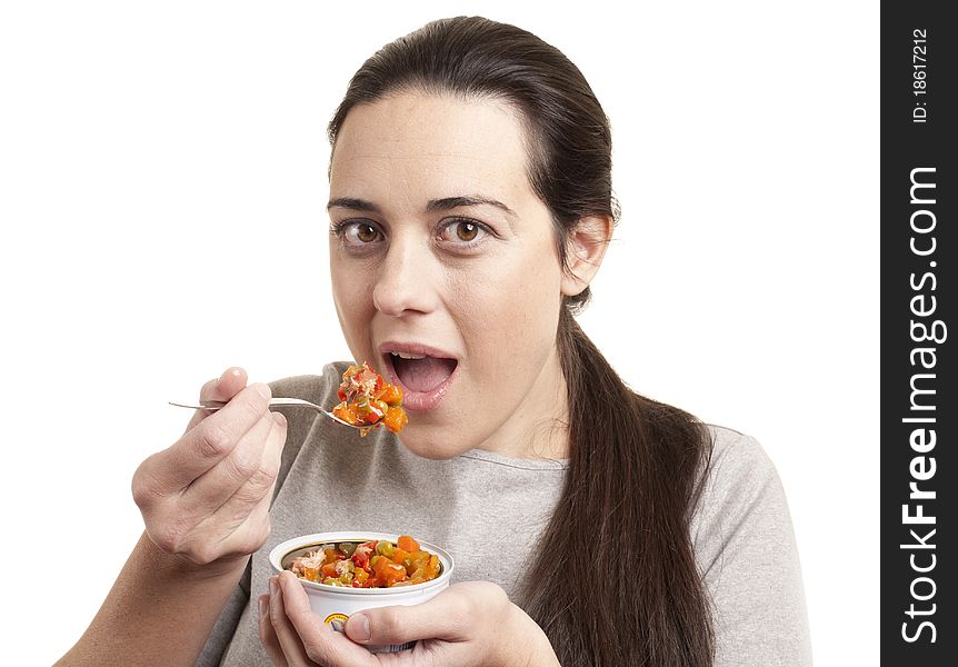 Portrait of young happy woman eating salad isolated on white