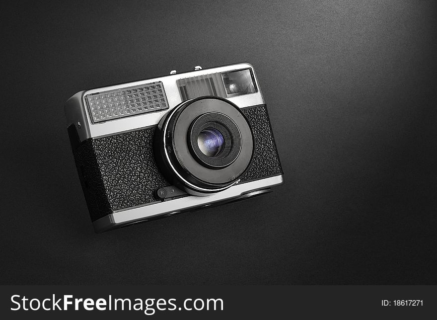 Classic vintage film rangefinder camera isolated on black grainy background. Classic vintage film rangefinder camera isolated on black grainy background