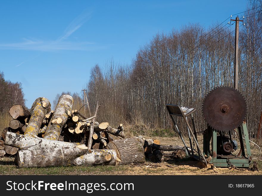 Old eletric circular saw and stack of firewood. Old eletric circular saw and stack of firewood