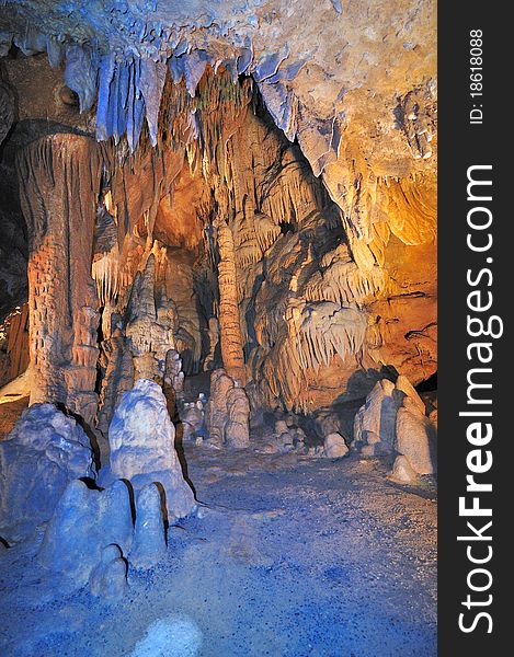 Red blue green rocks and pillars made up of minerals inside luray caves