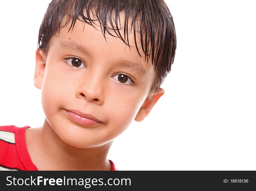Child with a small smile on his face over white background