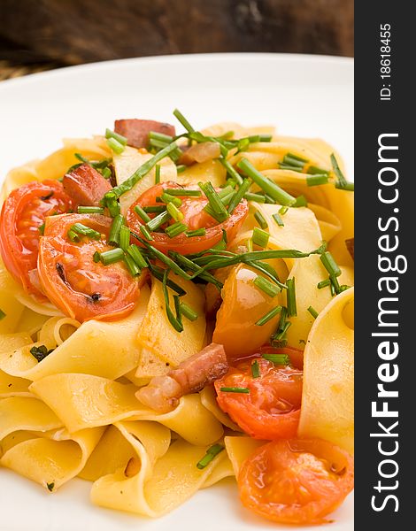 Photo of delicious pasta with bacon and tomatoes