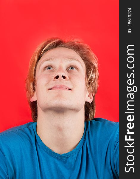 Man looking up at copy-space with red background. Man looking up at copy-space with red background