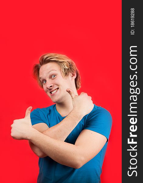 Man doing two thumbs up with red background. Man doing two thumbs up with red background