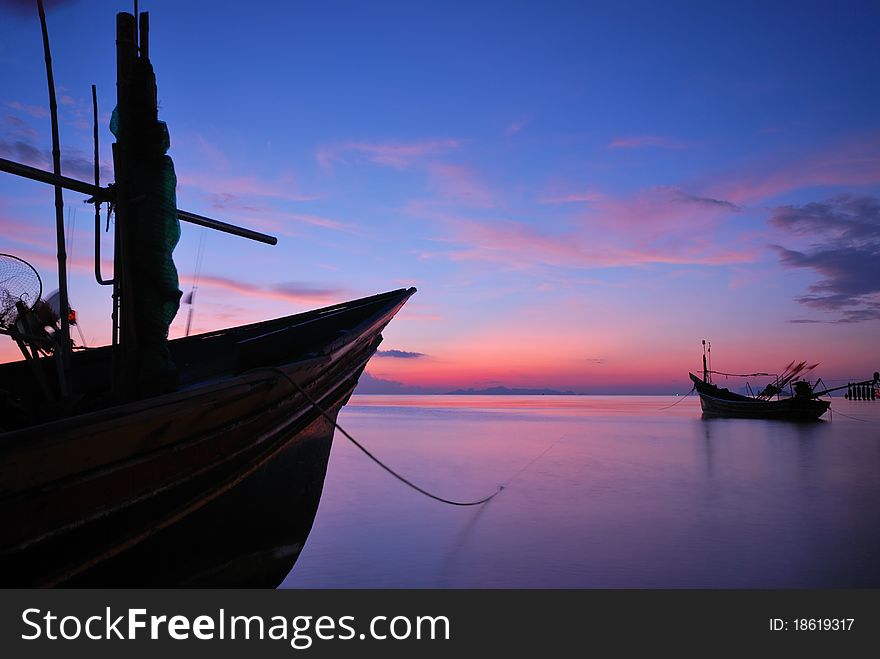 Fisherman boat at twilight with long exposure technique.