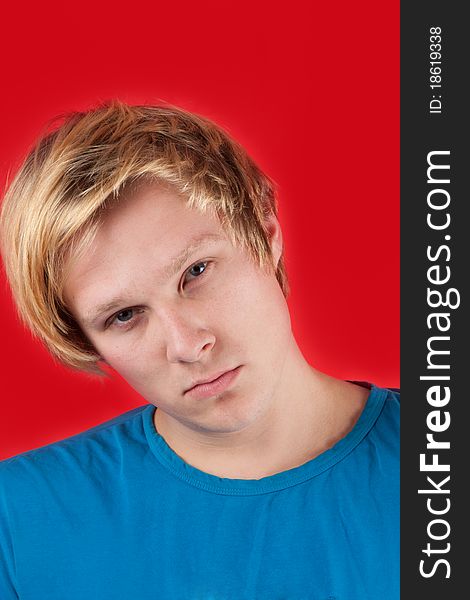Handsome young man on red background