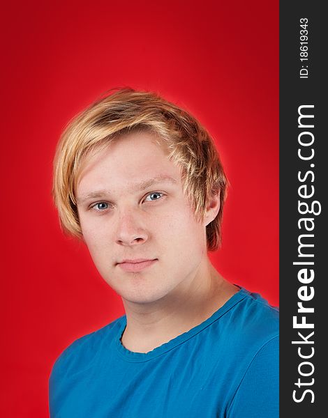 Handsome young man on red background