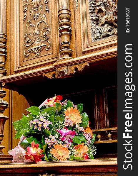 Bunch of wedding flowers on a old-style sideboard