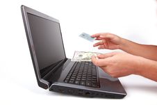 Laptop And Hand Give Credit Card Or Money Royalty Free Stock Photos