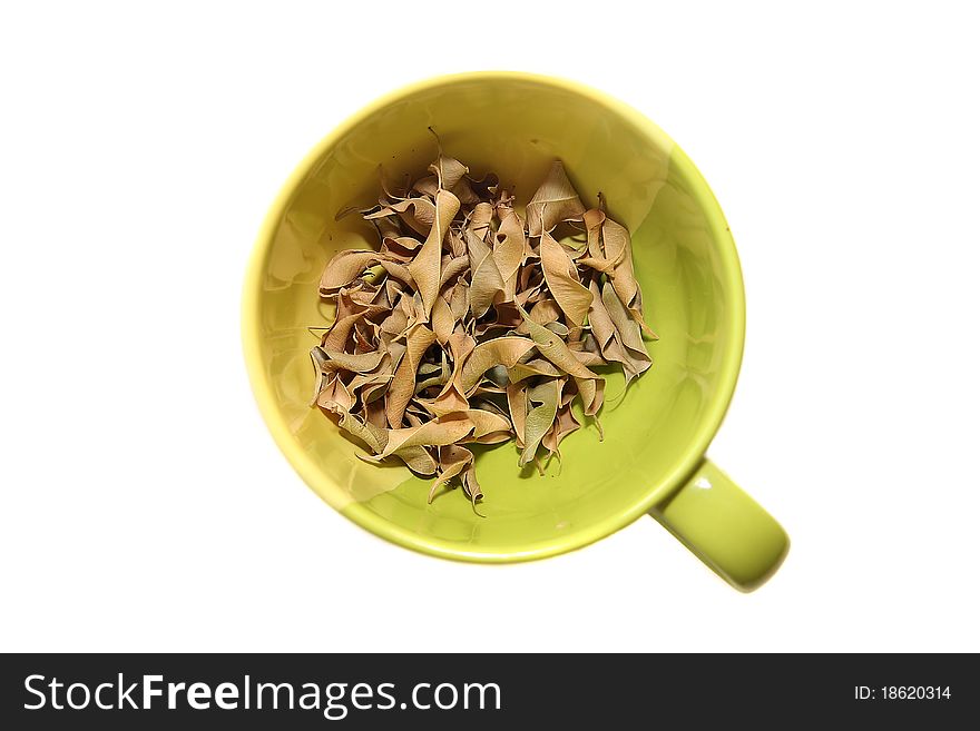 Cup of dried leafs on white background