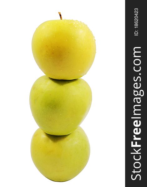 Three ripe yellow apples standing the friend on the friend on the isolated white background. Three ripe yellow apples standing the friend on the friend on the isolated white background