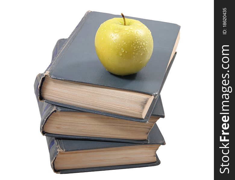 Three old books, lying the friend on the friend, with an apple on the isolated white background. Three old books, lying the friend on the friend, with an apple on the isolated white background