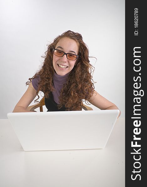 Beautiful teen girl alone with white laptop computer