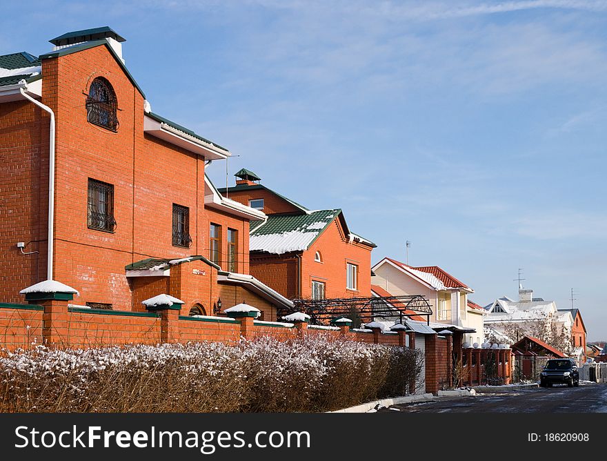 Cottage of red brick in the winter landscape