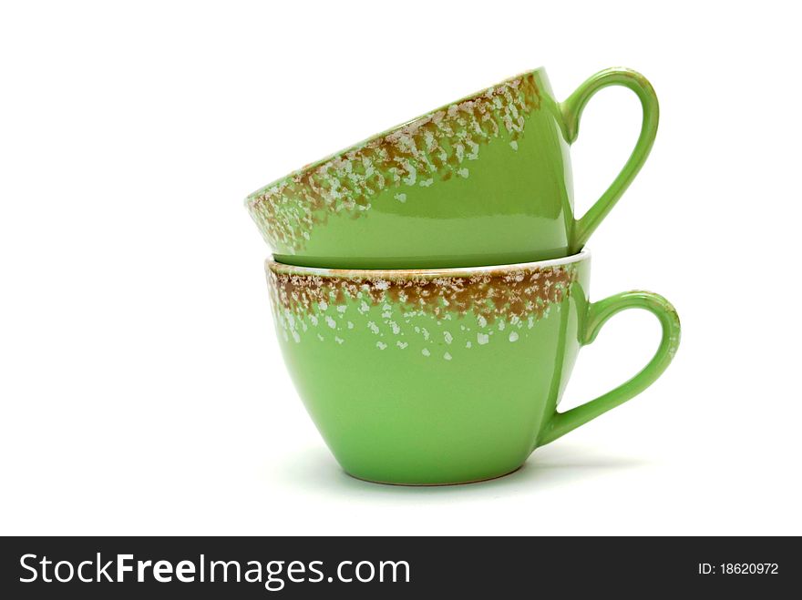 Two cups of green with ornament on white background.