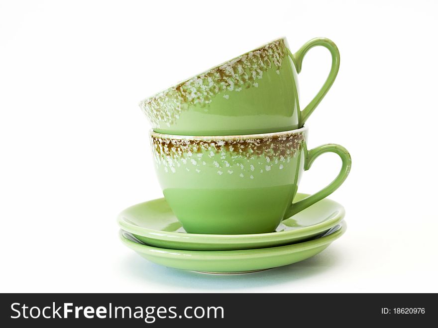 Two cups of green with ornament on white background.