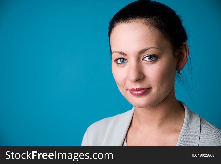 The woman on a dark blue background close up. The woman on a dark blue background close up