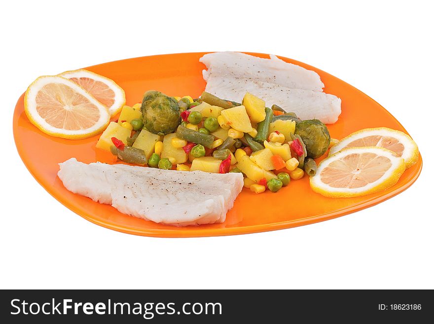 Vegetables and fish on orange plate isolated on white background