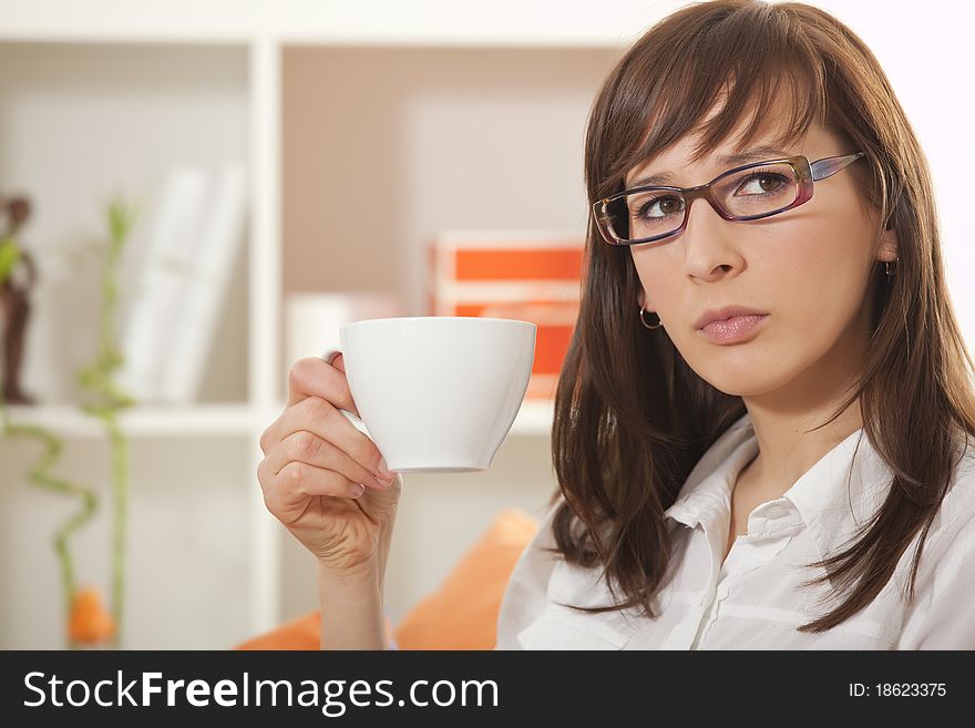 Woman in business shirt with cup coffee in her apartment. Woman in business shirt with cup coffee in her apartment