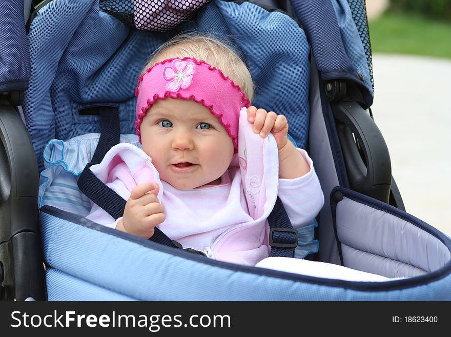 Sweat girl in blue pram. Sweat girl in blue pram