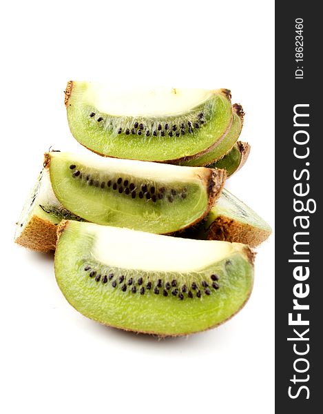 Many halves of a kiwi on a white background