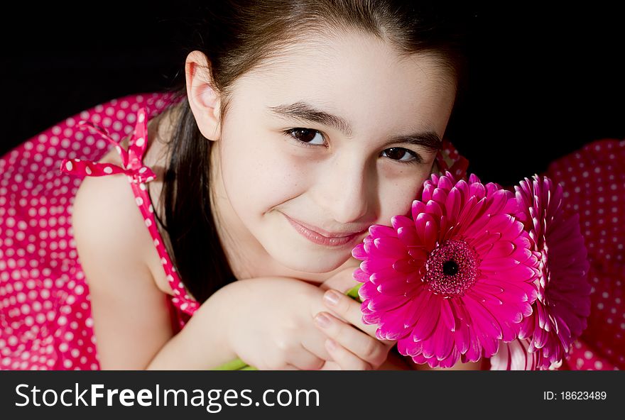 Cute little girl with a pink flower. Cute little girl with a pink flower.