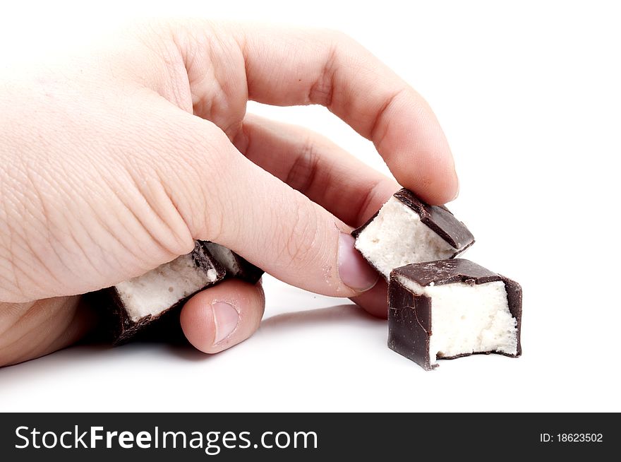 Delicious candy in hand on a white background