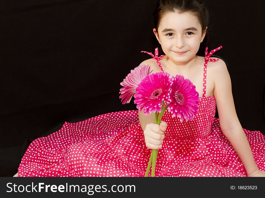 Little girl giving a bouquet of pink flowers to someone. Little girl giving a bouquet of pink flowers to someone.