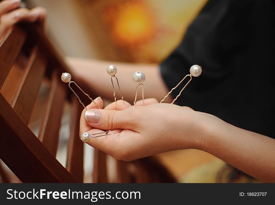 Close up of an arm holding decorated pins. Close up of an arm holding decorated pins