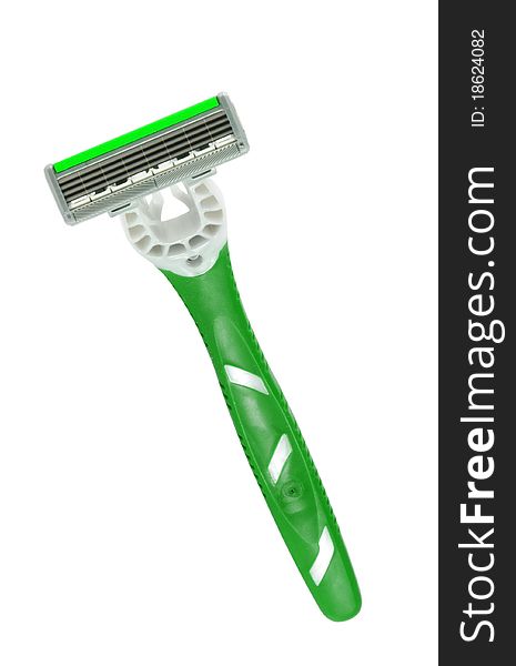Closeup of green shaving blade on white surface