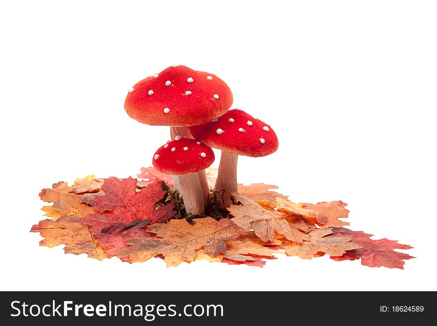 Red dotted decoration mushrooms with leaves isolated on a white background