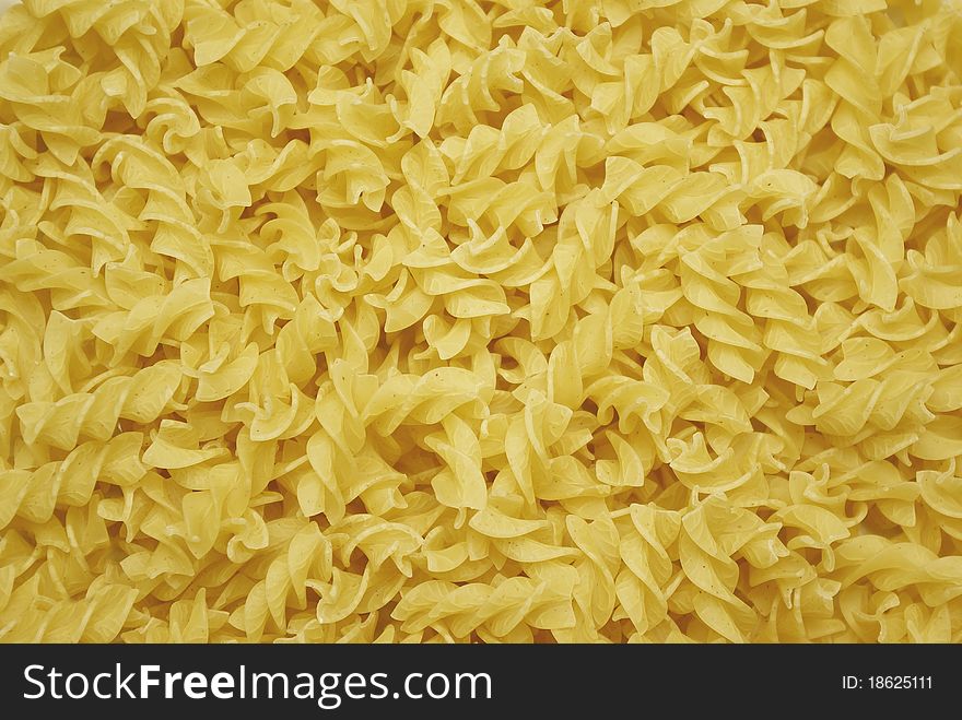 Background made of tasty yellow pasta