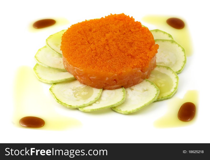 Studio photography of a salmon dish with zucchini and caviar isolated on white