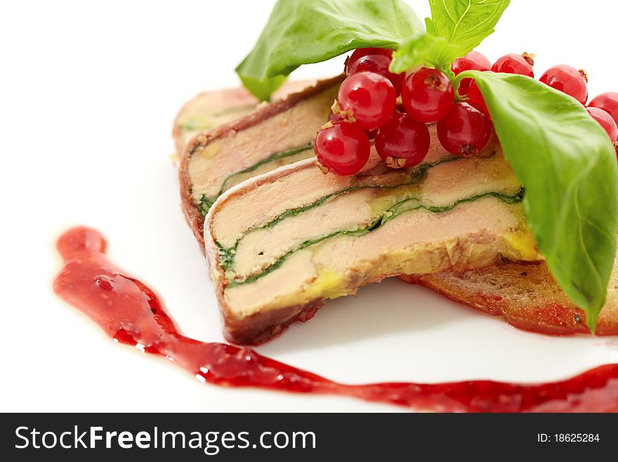 Close up photography of a piece of meatloaf in gravy with currants and mint leaves