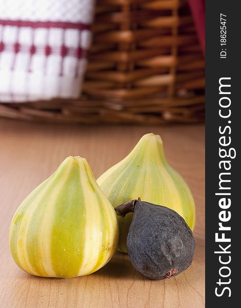 Ripe fruits of a fig on a wooden table.