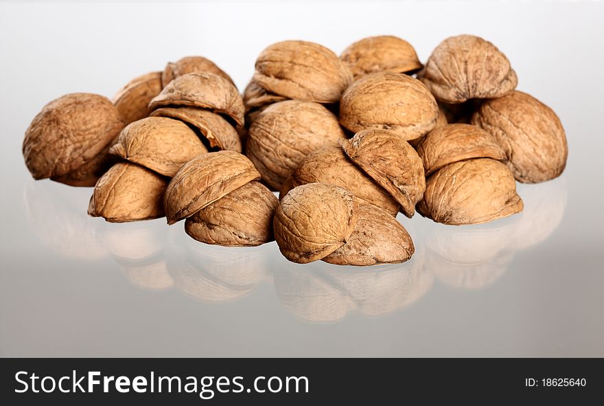 Hill of walnut's nutshells with reflection