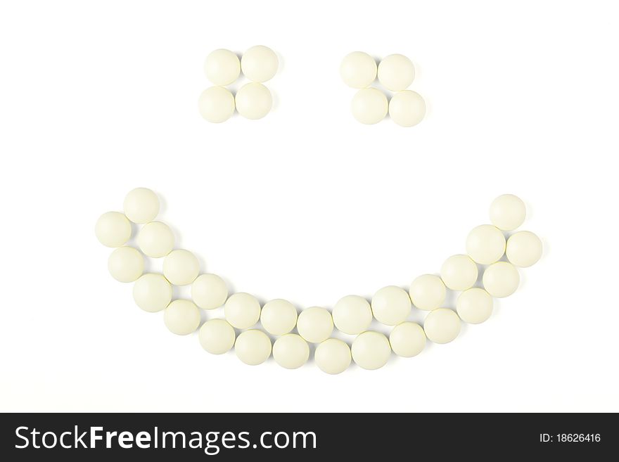 Yellow round tablets in the form of smiley. Yellow round tablets in the form of smiley.