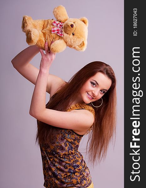 Beautiful longhair girl is holding the teddy bear. Beautiful longhair girl is holding the teddy bear