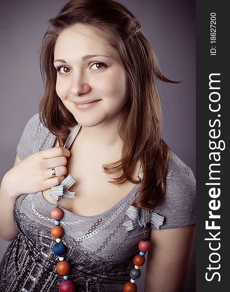 Pretty young girl in colorful beads with ribbons