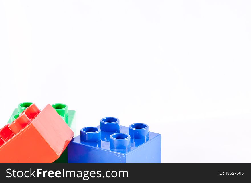 Plastic building blocks on white background. Bright colors.