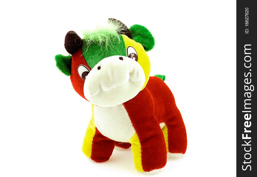 A toy multicoloured cow on a white background