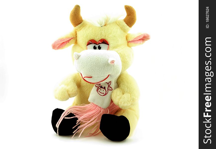 A toy peach cow on a white background