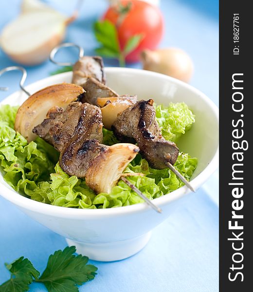 Grilled liver kebab with onion and lettuce