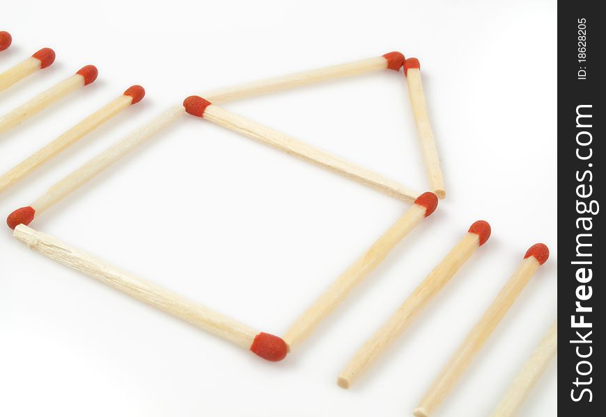 Red matches demonstrating a house with a fence. Red matches demonstrating a house with a fence.