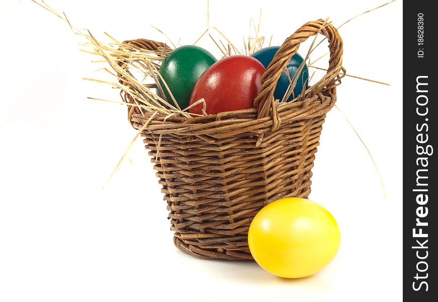 Some easter eggs in a basket isolated on white background